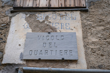 Street name plate in a village in the Occitan region (Ligurian Alps, Realdo, Imperia).  Is a region between France and Italy, where the ancient medieval French is spoken, called "Langue d'Oc".