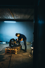 Fototapeta premium Motorcycle repair. Disassembled motorcycle. Fixing motorcycle standing in repair shop. Instruments and equipment. 