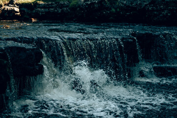 Water and waterfalls at Ingleton in the Yorkshire countryside with a retro film look