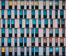 colorful sunset reflected on the windows of a modern building