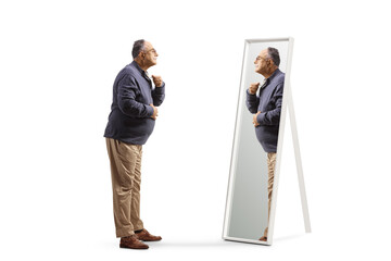 Full length profile shot of a mature man getting ready and looking at a mirror