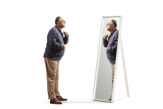 Full Length Profile Shot Of A Mature Man Getting Ready And Looking At A Mirror