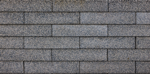 flat texture and full-frame background of gray long rectangular brick pavement.