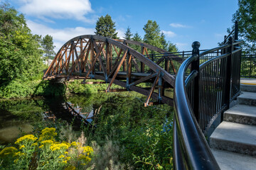 Handrail and steps lead to footbridge over lazy river