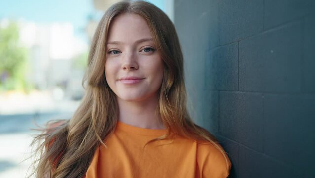 Young woman smiling confident standing at street