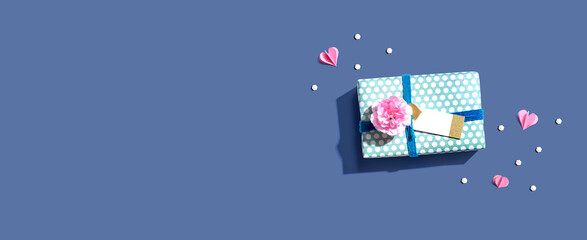 Appreciation theme with a gift box and a pink carnation flower