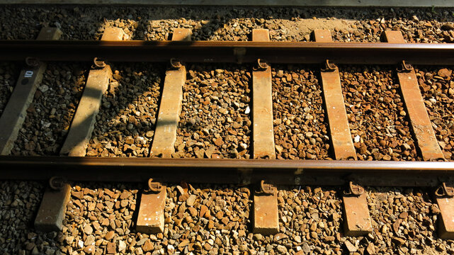 metal railroads lines, rail and crushed stone. railway track. train track.