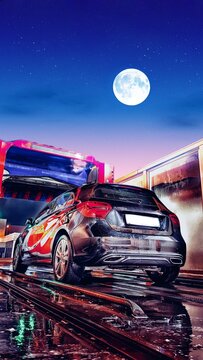 Macchina nera in autolavaggio con luna