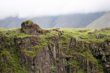 Views of a steep grassy cliffside on lingmell fell in the Lake District, England