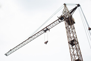 Construction crane on a white sky background.  Bottom view. 