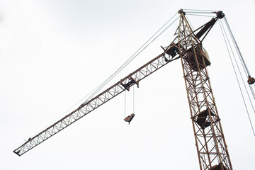 Construction crane on a white sky background.  Bottom view. 