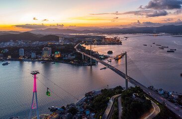 Aerial view of Bai Chay bridge at night in Ha Long City, Vietnam, timelapse traffic
