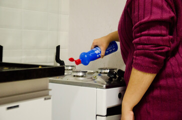 Woman cleaning the oven. Oven. Degreaser. Domestic services. Kitchen. 