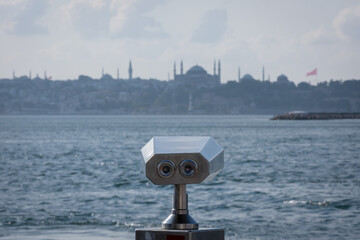 Coin operated binocular viewer and istanbul view in the background. touristic telescope.