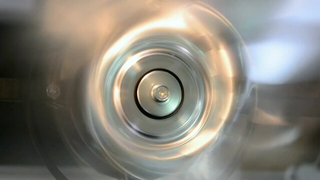 rotated silver industrial metal ring closeup with vibrance effect, permanent motor vibration, industry oscillation, flutter diversity