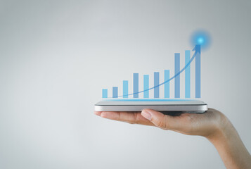 Business growth,Business finance and technology,New Business,stock market concept.,Smartphone on hand showing chart positive indicators vitual.,copyspace.