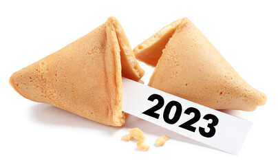 Tasty fortune cookie and paper with number 2023 on white background