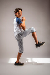 Teenage baseball player practices pitching the ball