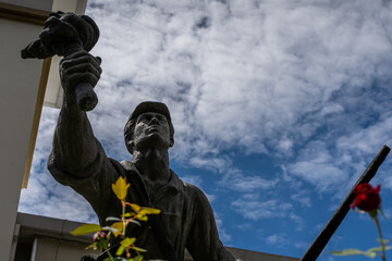 Fototapeta na wymiar Closeup view of the statue -monument of the national hero Juan Santamaria- next to the Costa Rica Flag