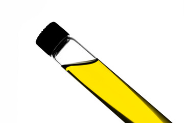 Yellow food coloring added to water in glass test tube with screw cap