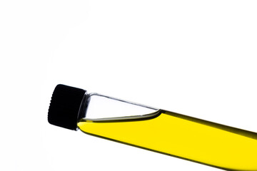 Yellow food coloring added to water in glass test tube with screw cap