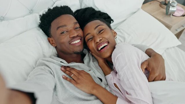 Selfie influencer couple in bed and portrait smile for fun indoor weekend or waking up together in the morning. Fun, happy black people in bedroom and a POV portrait photo for social media content