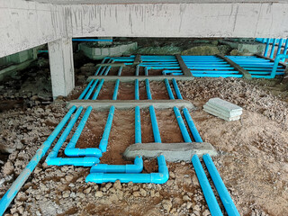 Installation of water pipes in the building. Water pipe system under the building.Installing water...