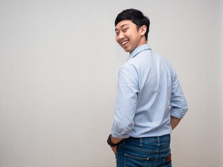 Positive man blue shirt happy smile turn back to looking at camera