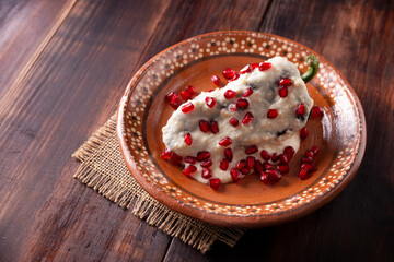 Chile en Nogada, Typical dish from Mexico. Prepared with poblano chili stuffed with meat and fruits and covered with a special walnut sauce. Named as the quintessential Mexican dish.