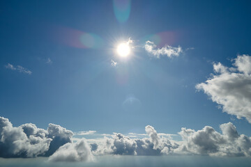 Aerial view from airplane window at high altitude of earth covered with puffy cumulus clouds...