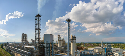 Aerial view of oil and gas refining petrochemical factory with tall refinery plant manufacture...