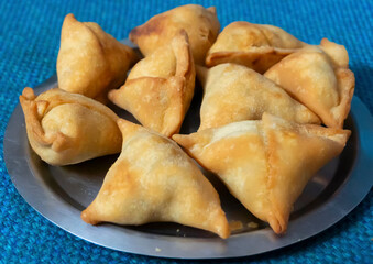 Homemade Samosa, samsa or smosa. A vegetarian spicy Indian special traditional street food. Iftaari dish, Selective focus.