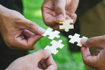 Group of businessperson holding pieces of jigsaw puzzle.