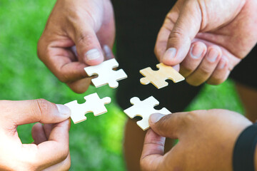 Group of businessperson holding pieces of jigsaw puzzle.