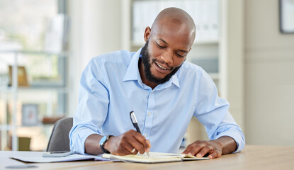 Businessman writing in a notebook while planning a strategy and working in an office. Happy male...