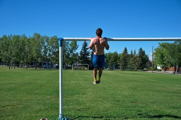 Rear view of mature man doing endurance workout in nature
