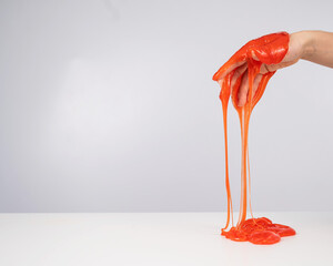 Red slime flowing down from a woman's hand on a white background. 