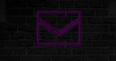 Image of glowing neon envelope icon on brick wall