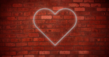 Image of glowing neon heart icon on brick wall