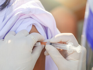 Vaccination, the concept of disease prevention. Take your child to get vaccinated against COVID or the flu. A professional female doctor gives the patient an antiviral drug.