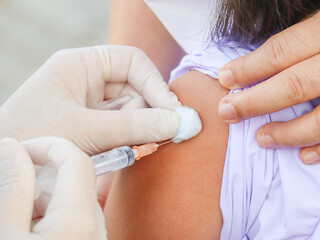 children's coronavirus vaccine sit vaccinated with syringe against covid-19.