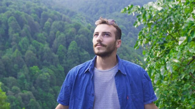 Freeman Adventure.
A young, free and passionate hiker seeking adventure. He is walking in a very beautiful landscape: a meadow of green grass.
