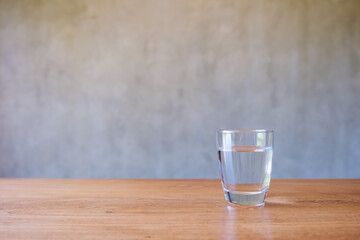 A glass of drinking water on wooden table