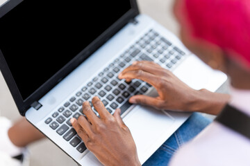 Top view of hands of a woman using a laptop