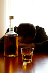 drunken man with a glass and bottle of alcohool