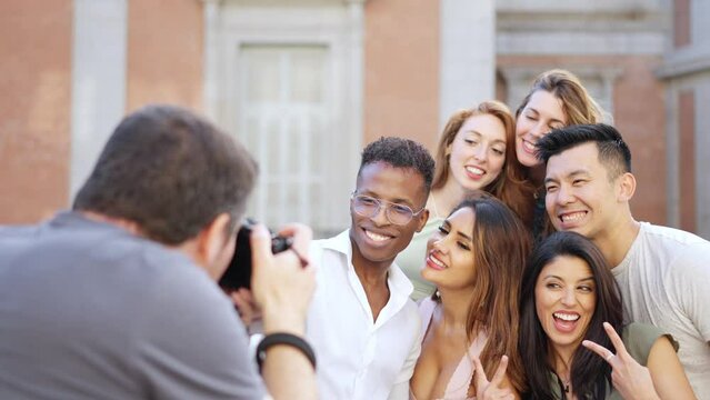 Photographer taking a photo of a multiethnic group of friends