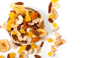 Fruit and nut assortment of peanuts, raisins, pineapple, almonds, cashews and bananas.