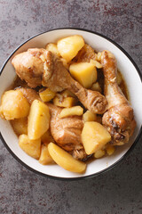 Semur Ayam Kentang Kecap Chicken Potatoes Smoor closeup on the bowl on the table. Vertical top view from above