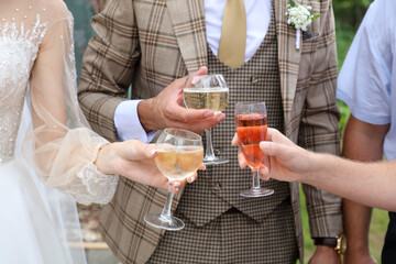 The bride and groom drink champagne at the wedding.