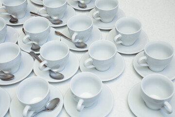 White tea cups with spoons